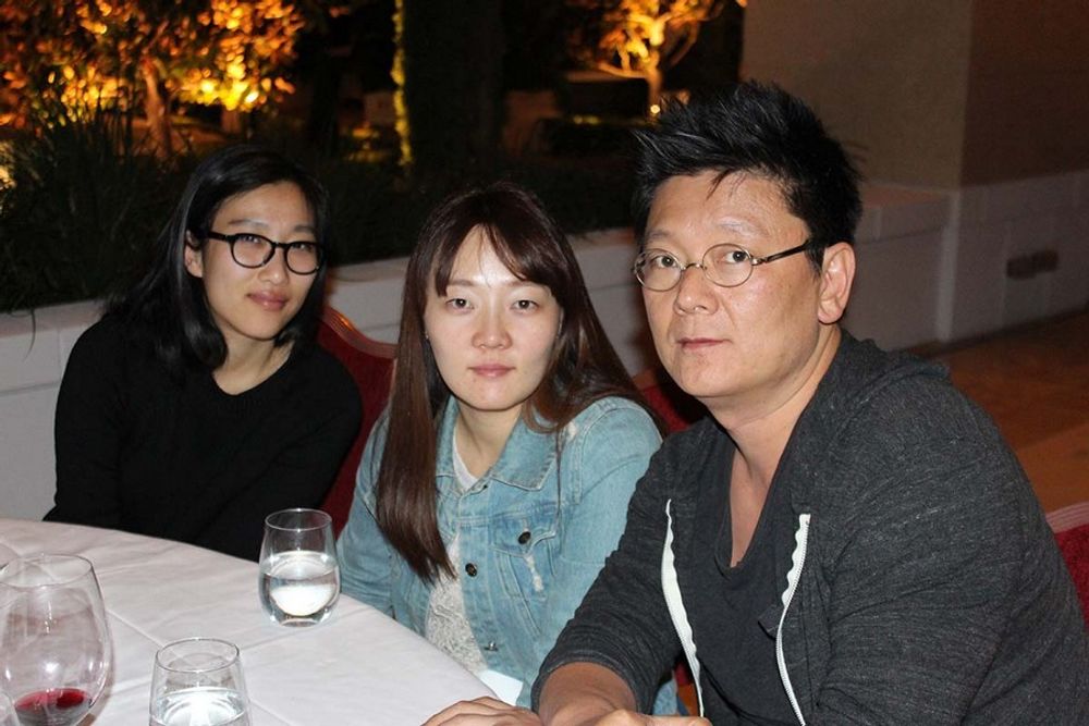 Steve Keum, Ji Min Yoo, and Jeongsil Lee enjoying dinner at the patio party