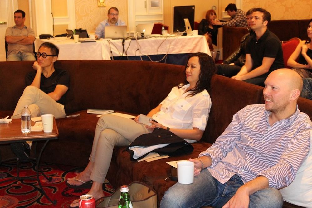 Naoki Ito, Jureeporn Thaidumrong, and Philip Ahlqwist enjoying their time in the judging room, while a group of young creatives sit in on statue discussions