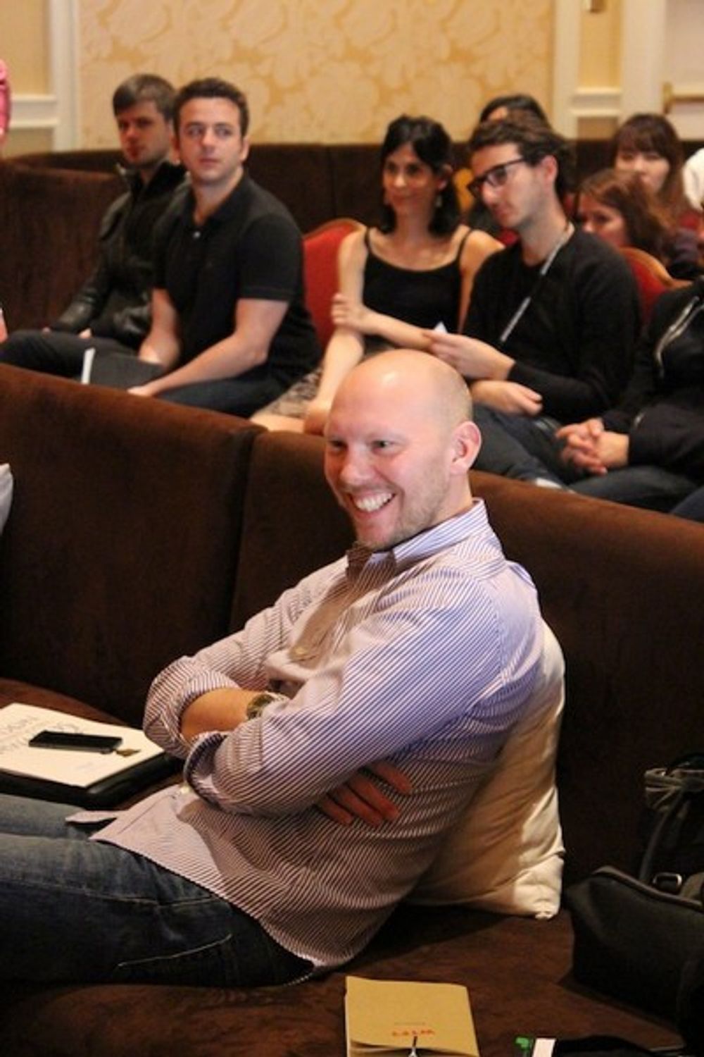 Philip Ahlqwist having a great time in the judging room, while a group of young creatives sit in on statue discussions