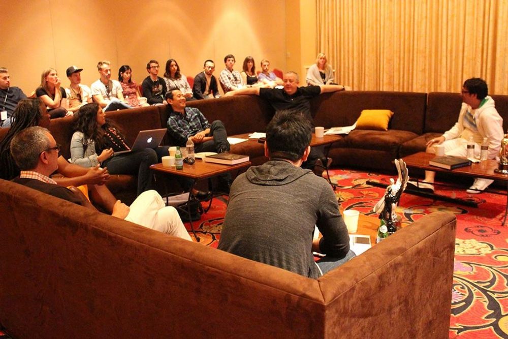 The Non-Traditional Jury enjoying discussions, while the young creatives sit in