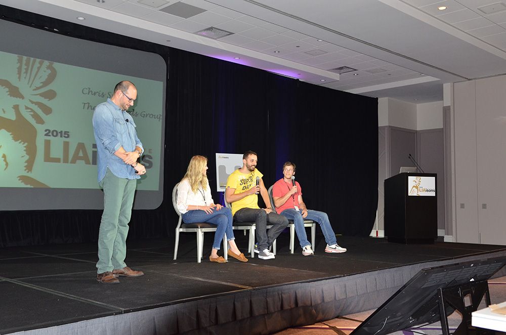 Chris Smith and three young creative volunteers on stage at Creative LIAisons