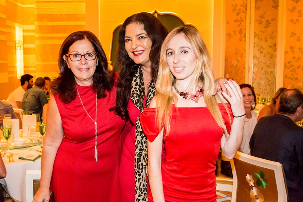 Patricia Censoprano, Doerte Spengler-Ahrens and Laurissa Levy dressed in red at Wing Lei